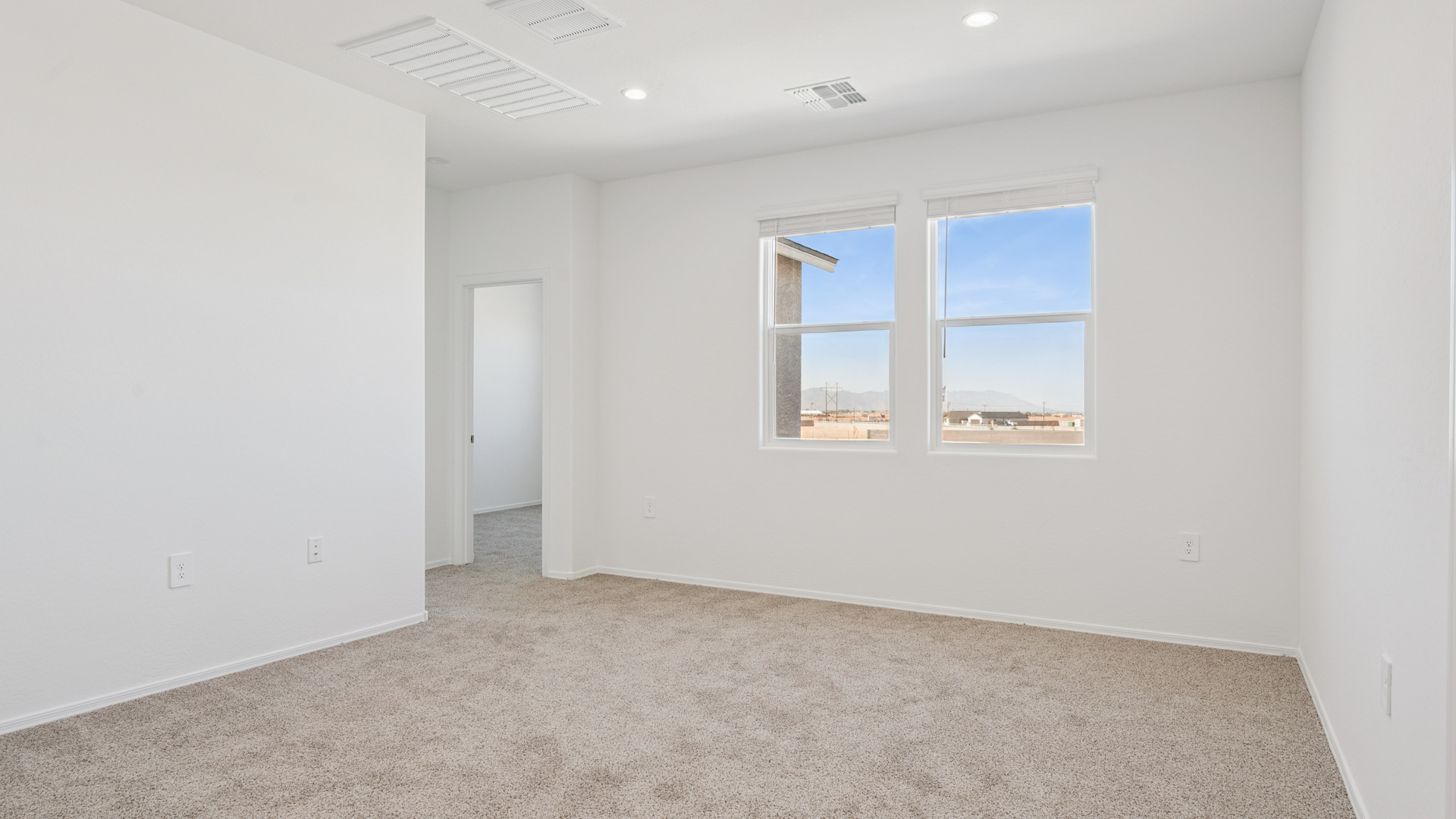 Upstairs play and seating area near large windows and the additional bedrooms.