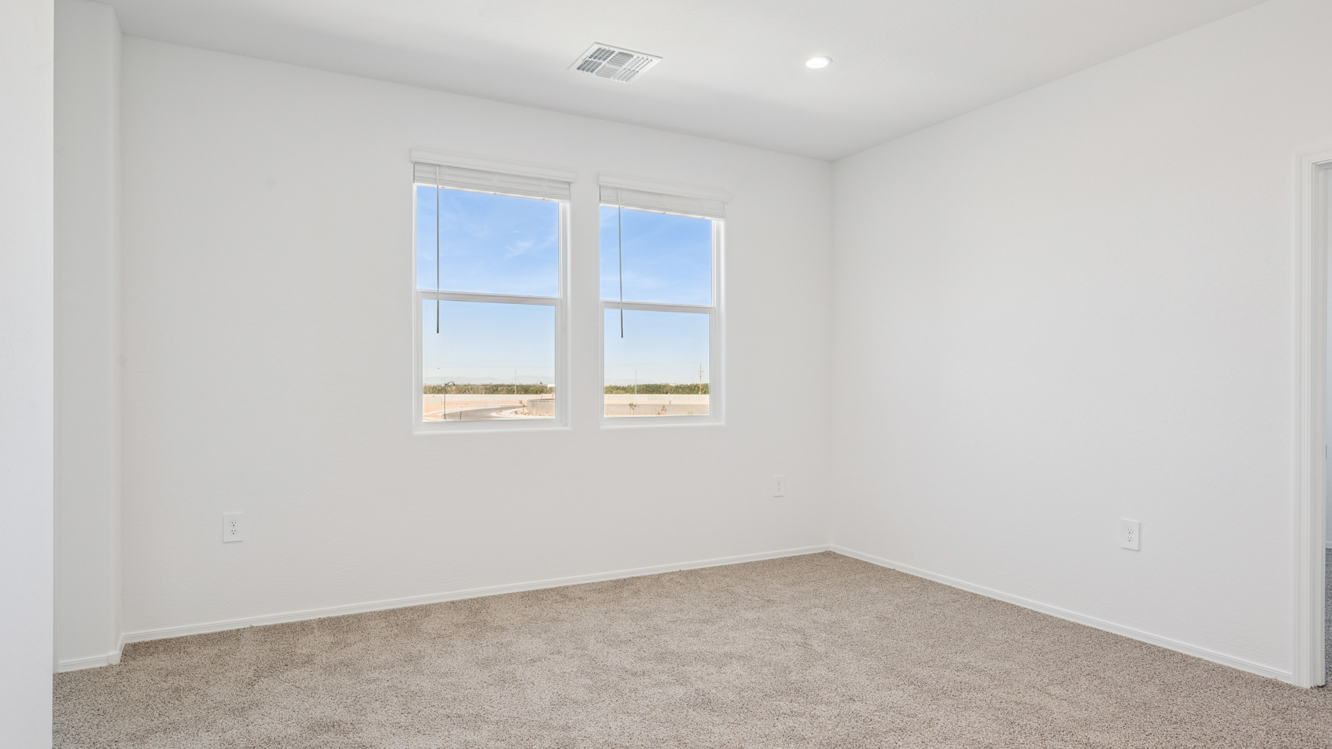 Upstairs play and seating area near large windows and the additional bedrooms.