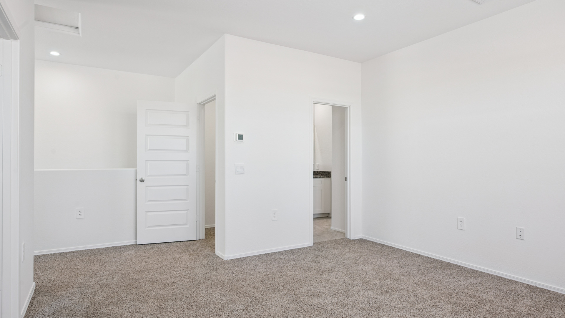 Upstairs play and seating area near large windows and the additional bedrooms.