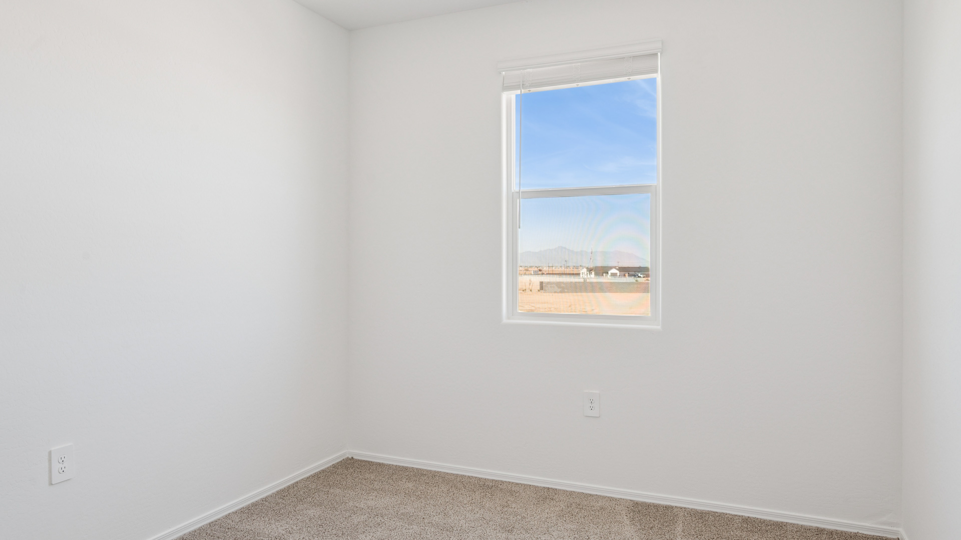 Comfortable guest bedroom featuring neutral-toned walls and a large closet.