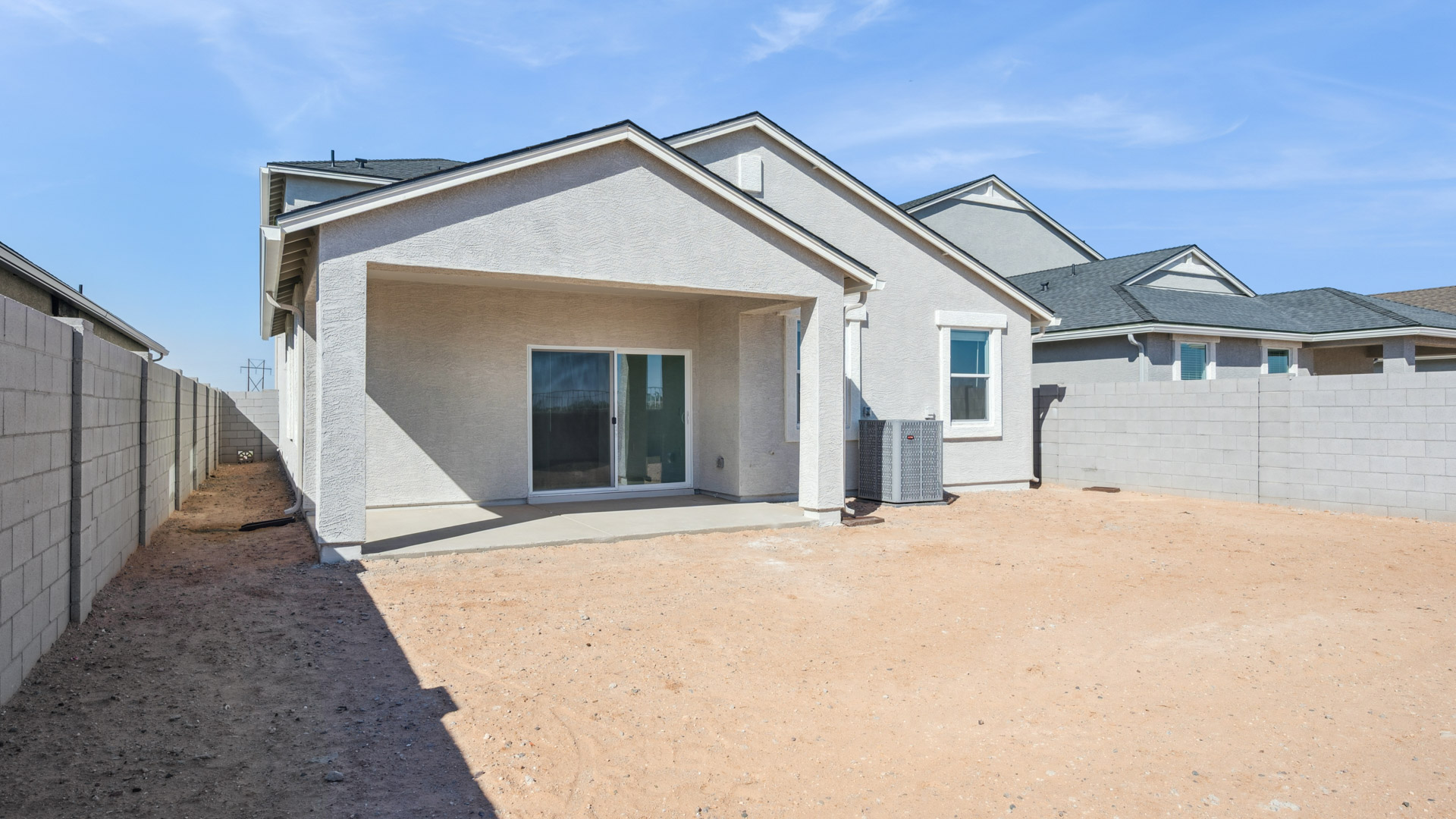 Large fenced-in backyard with a covered patio, perfect for outdoor entertaining.