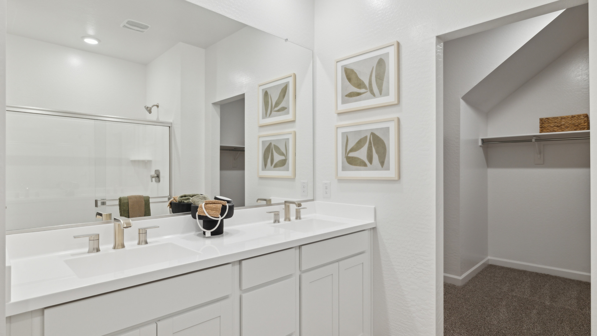 primary bathroom with dual vanities