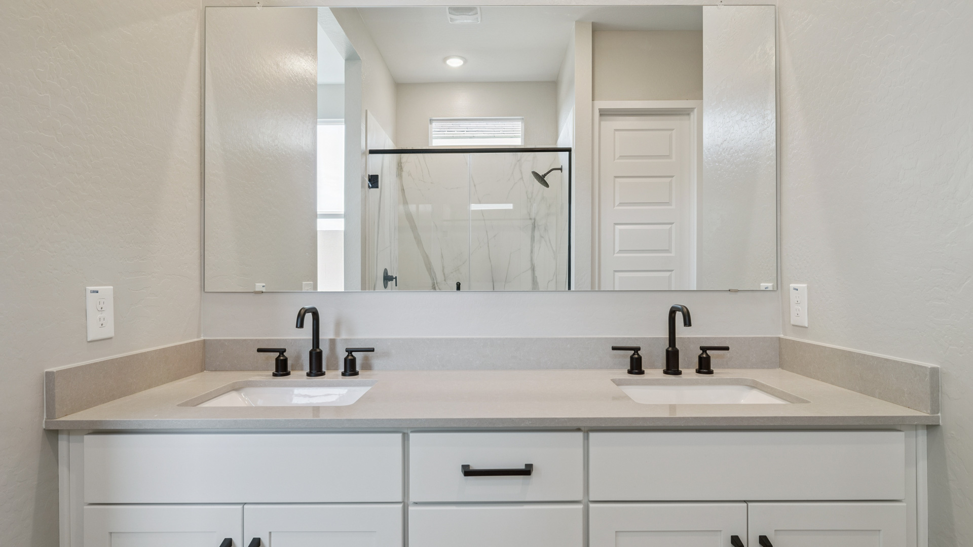 primary bathroom with dual vanities