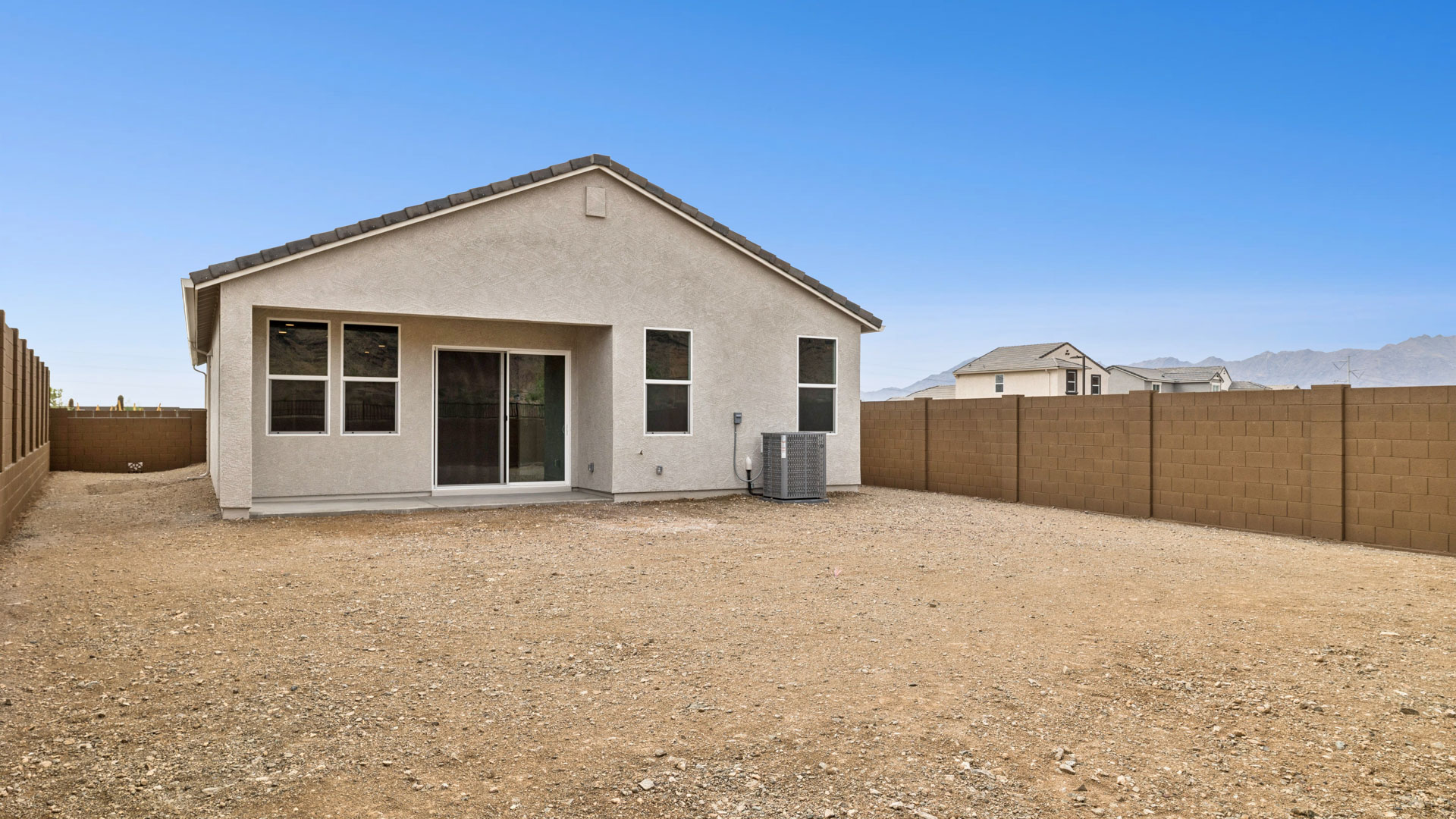 back of home with coverd patio