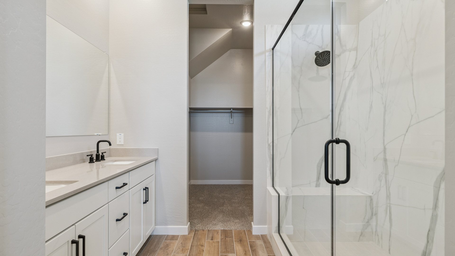 primary bathroom with dual vanities