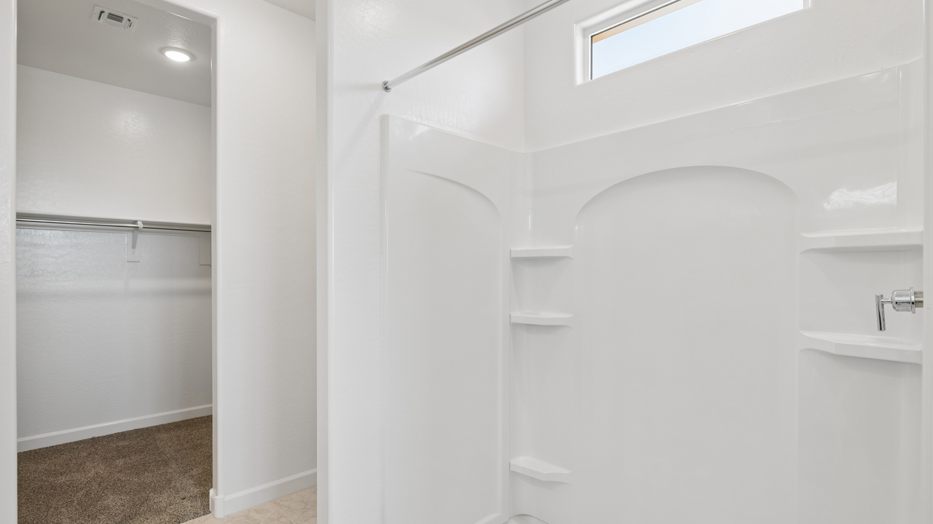 primary bathroom with dual vanities
