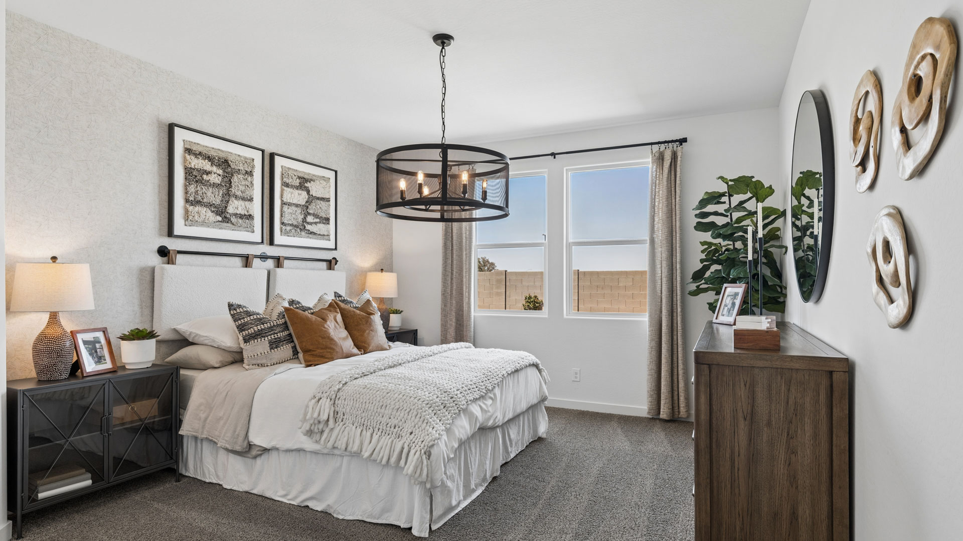 A spacious primary bedroom emphasizing open space and natural lighting.