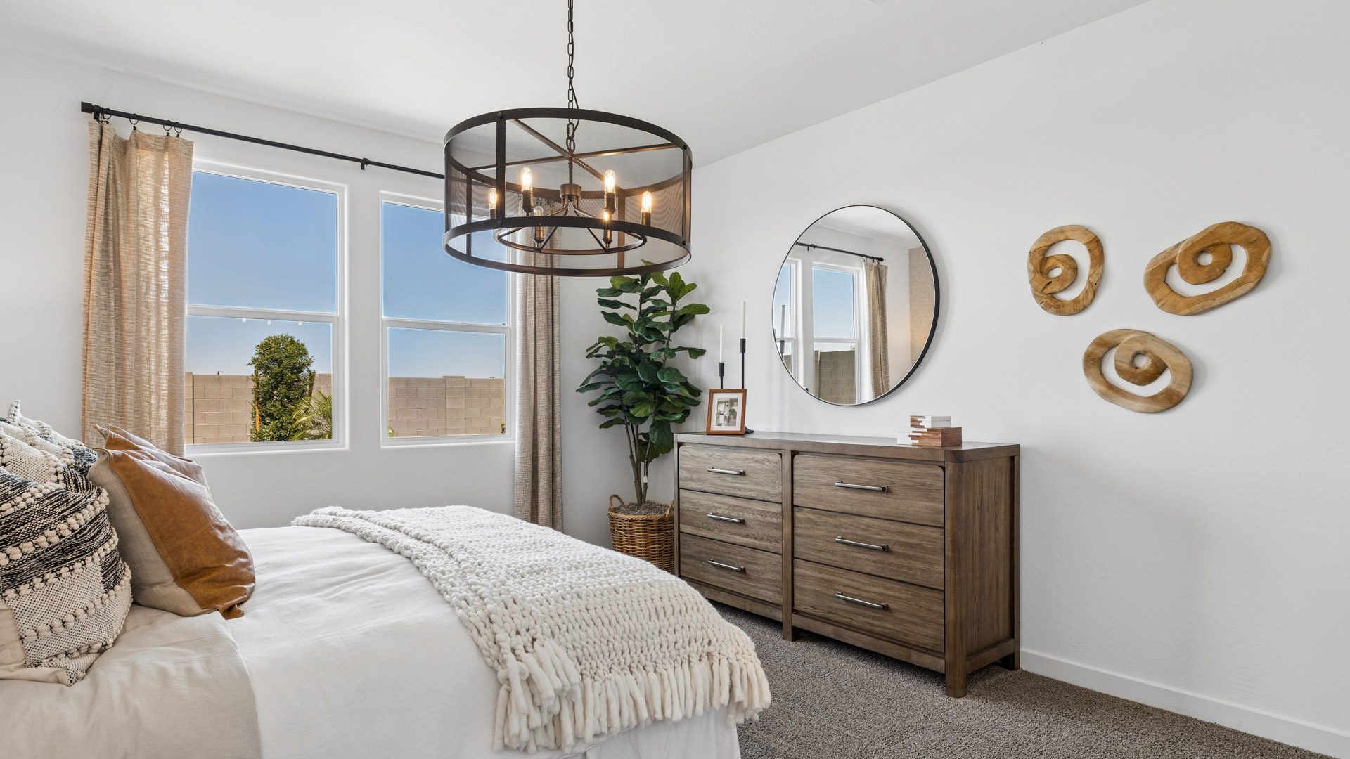 A spacious primary bedroom emphasizing open space and natural lighting.