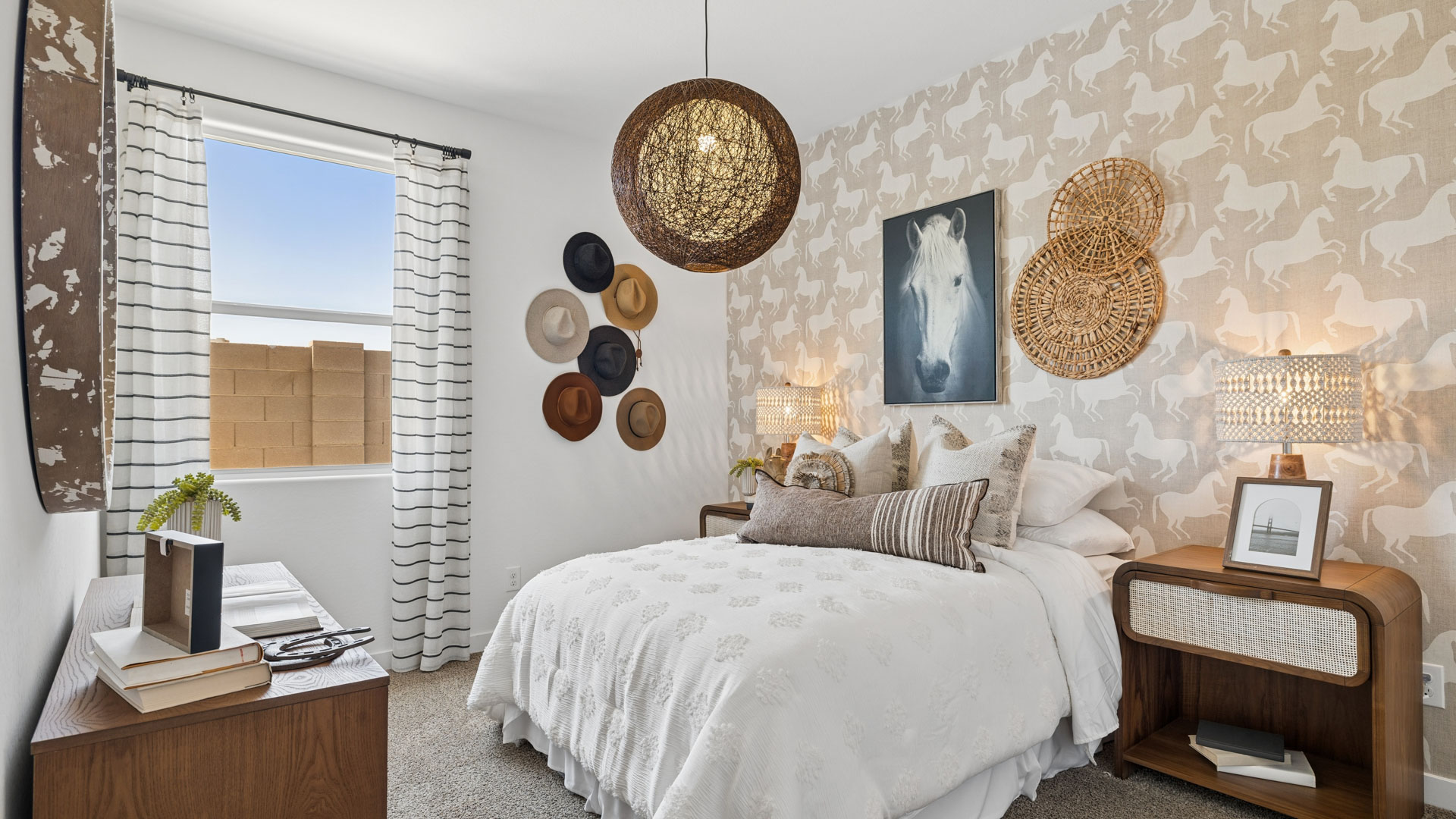 A vibrant kids' bedroom showcasing a neatly made bed, a stylish dresser, and a playful painting that adds charm.