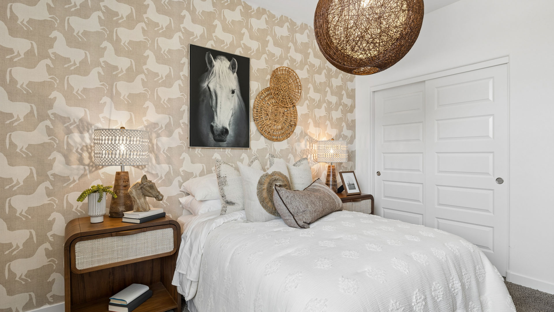 A vibrant kids' bedroom showcasing a neatly made bed, a stylish dresser, and a playful painting that adds charm.