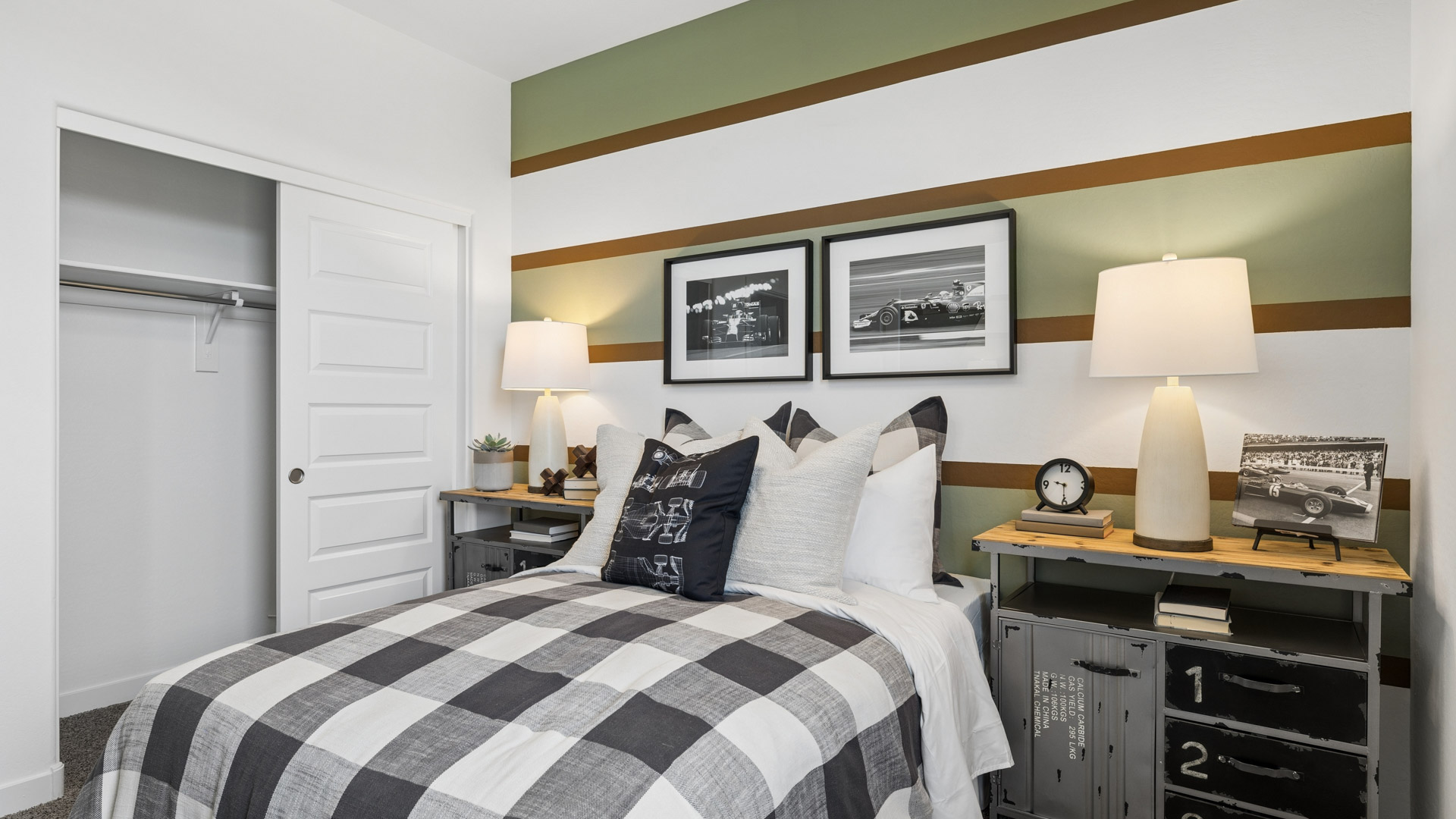 A vibrant kids' bedroom showcasing a neatly made bed, a stylish dresser, and a playful painting that adds charm.