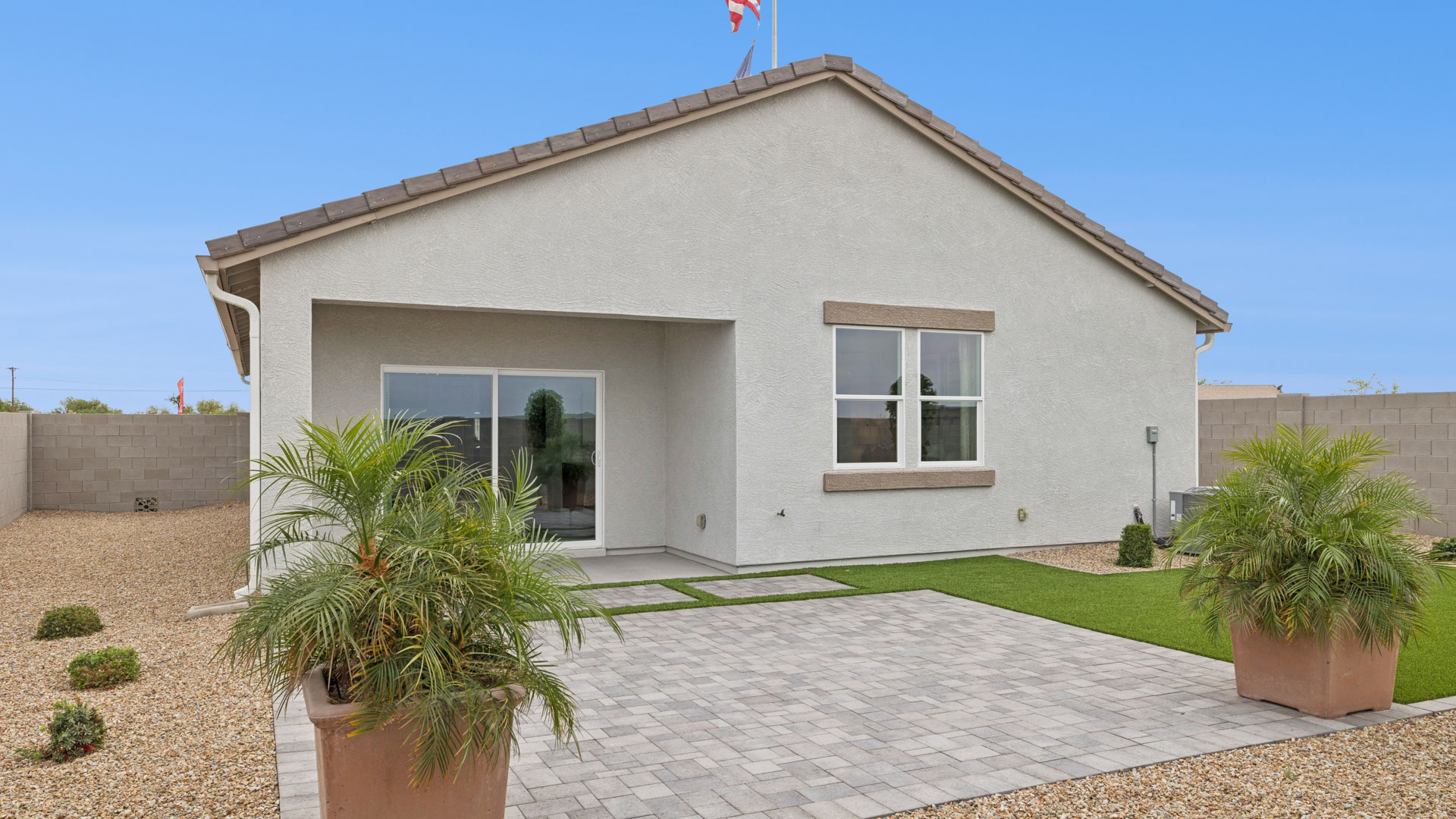 Large fenced-in backyard with a covered patio, perfect for outdoor entertainment.