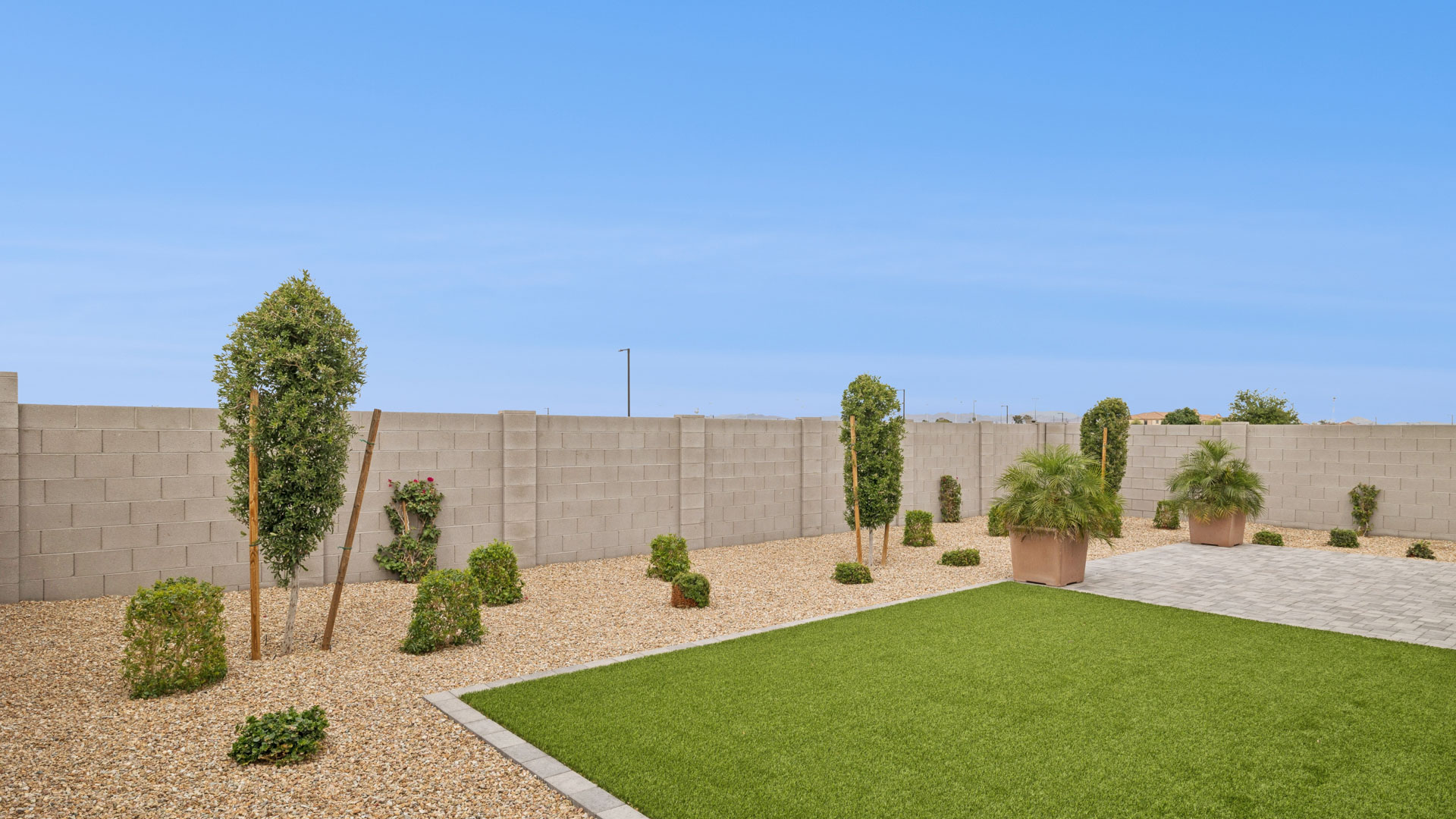 Large fenced-in backyard with a covered patio, perfect for outdoor entertainment.