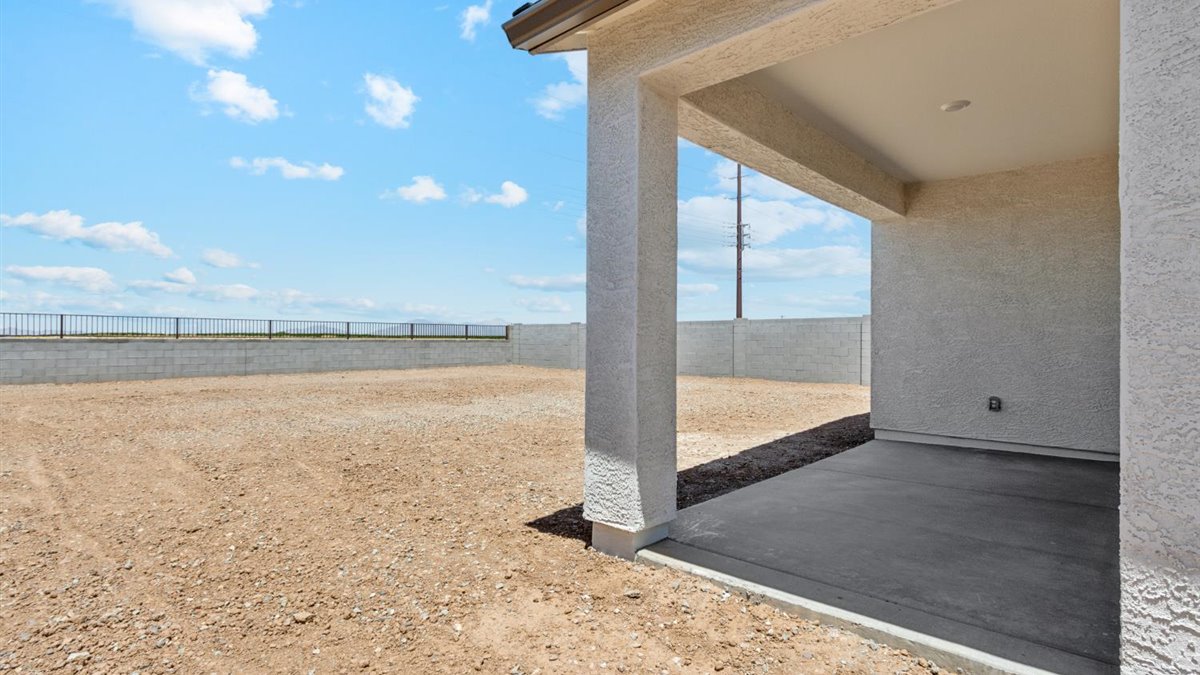 Large fenced-in backyard with a covered patio, perfect for outdoor entertaining.