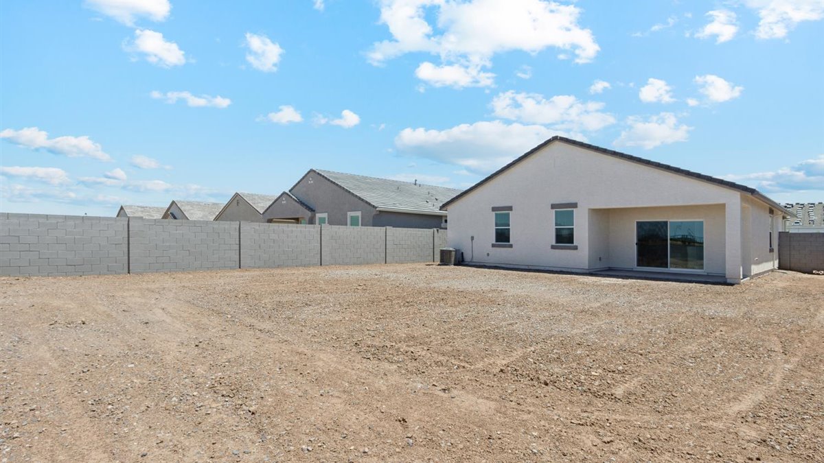 Large fenced-in backyard with a covered patio, perfect for outdoor entertaining.