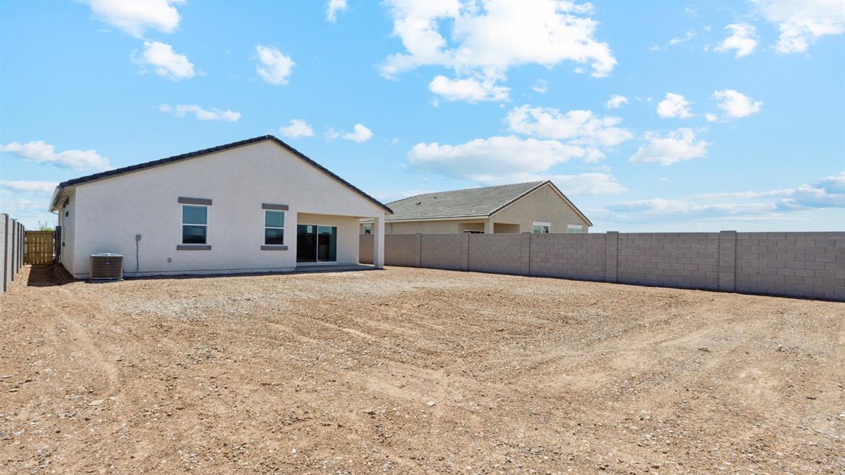 Large fenced-in backyard with a covered patio, perfect for outdoor entertaining.