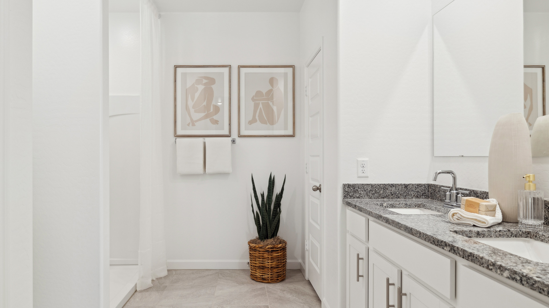 primary bathroom with dual vanities