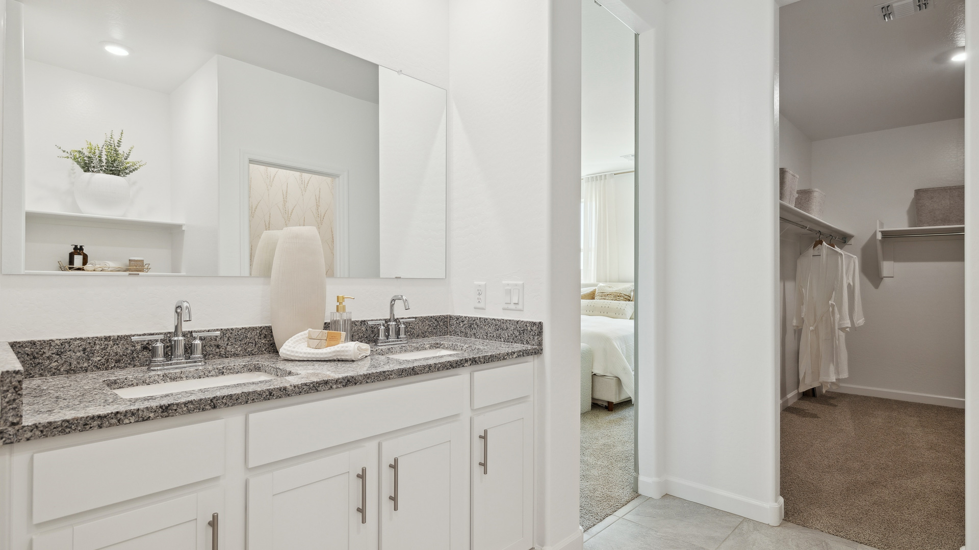 primary bathroom with dual vanities