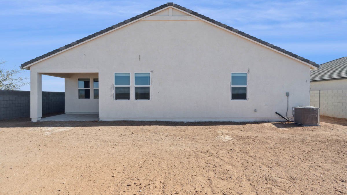 Large fenced-in backyard with a covered patio, perfect for outdoor entertaining.