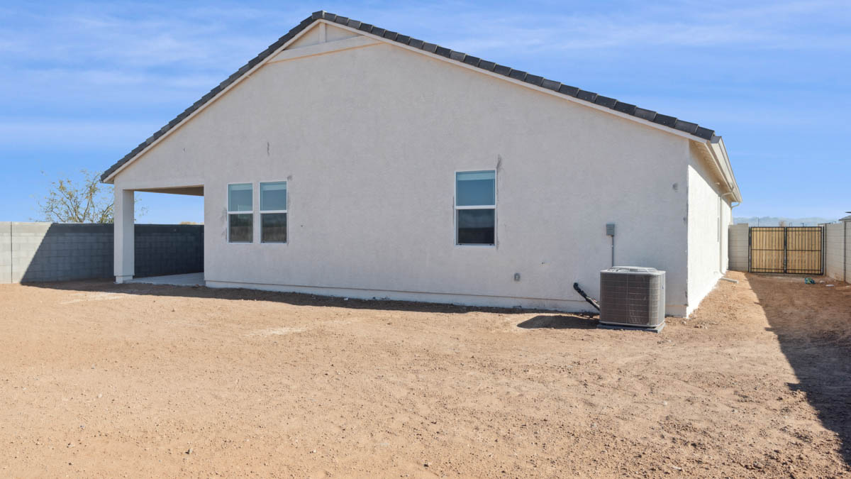 Large fenced-in backyard with a covered patio, perfect for outdoor entertaining.