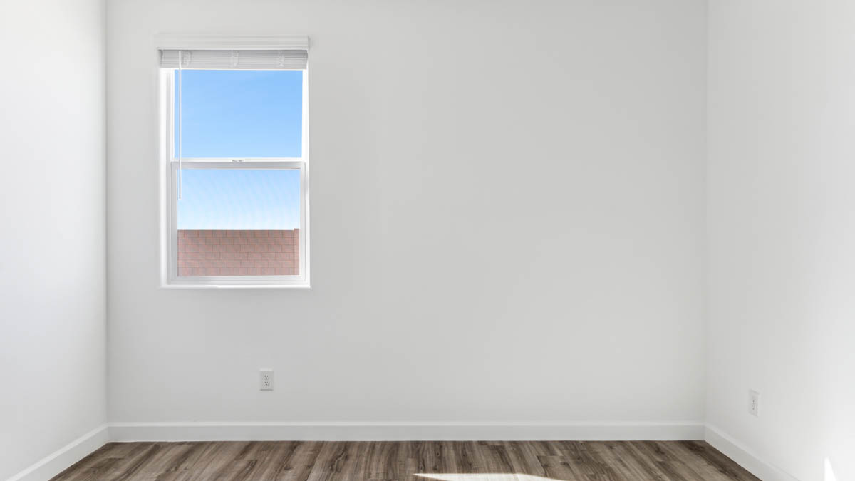 Comfortable guest bedroom featuring neutral-toned walls and a large closet.