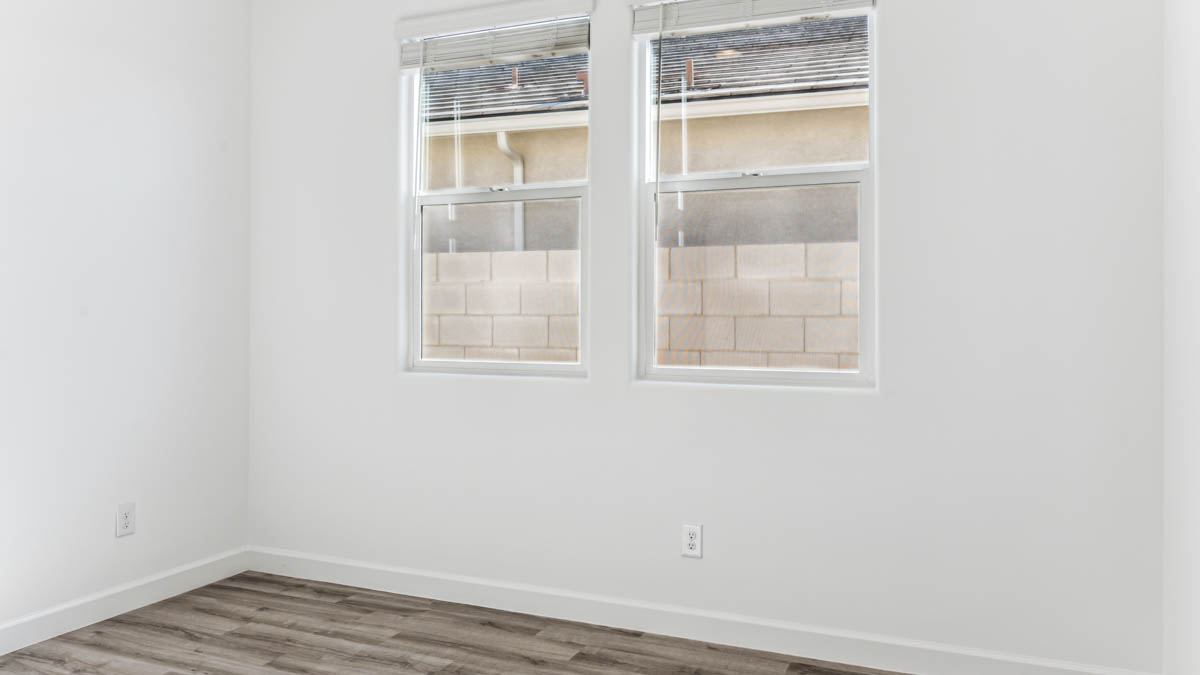 Comfortable guest bedroom featuring neutral-toned walls and a large closet.