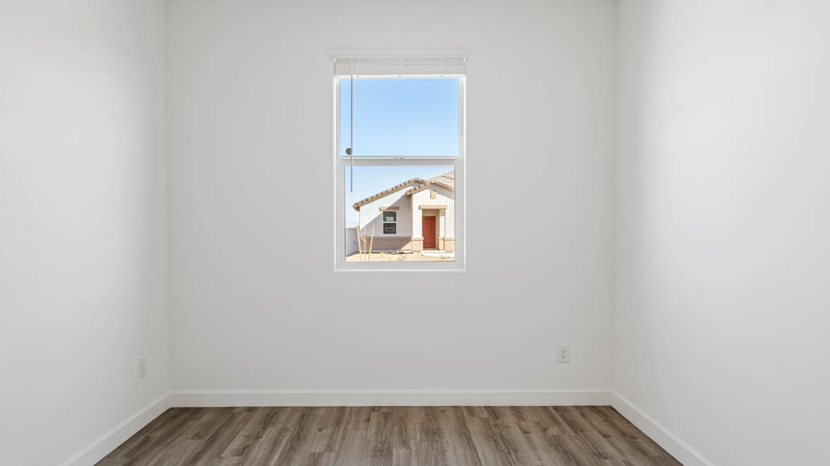 Comfortable guest bedroom featuring neutral-toned walls and a large closet.