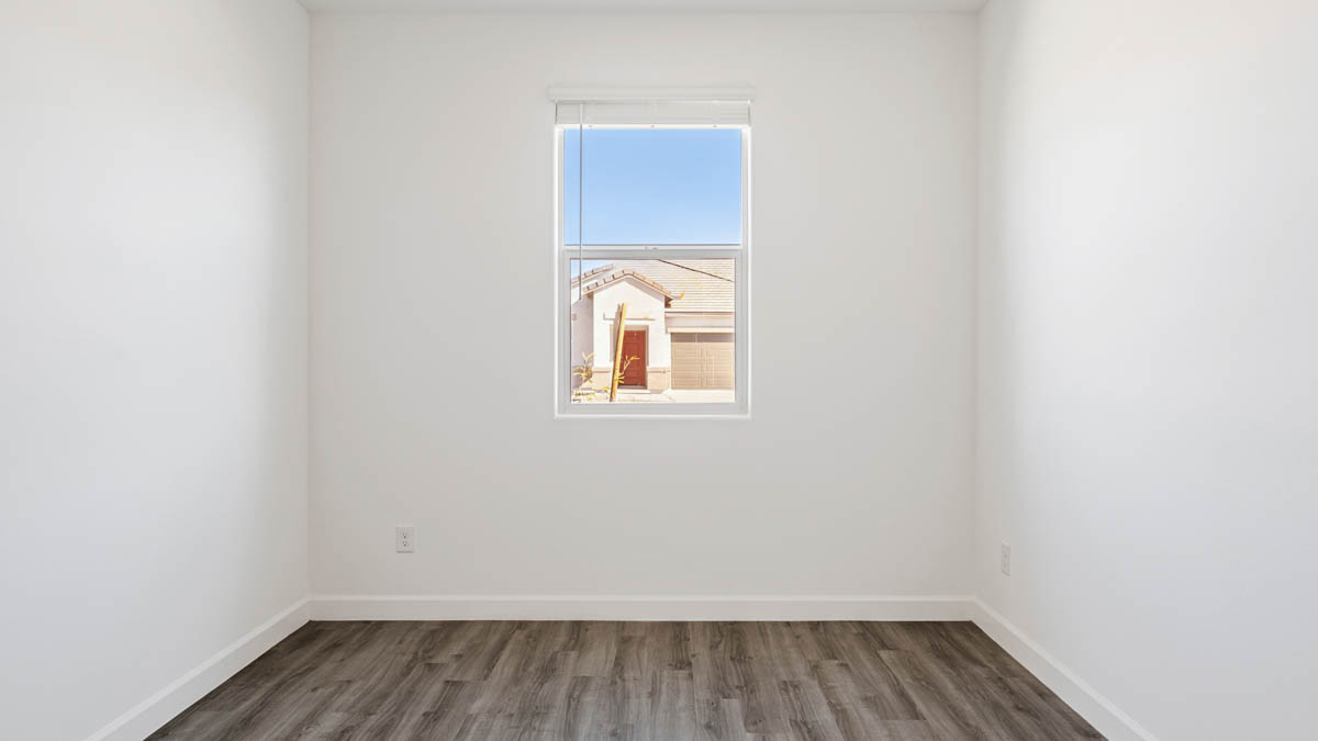 Comfortable guest bedroom featuring neutral-toned walls and a large closet.
