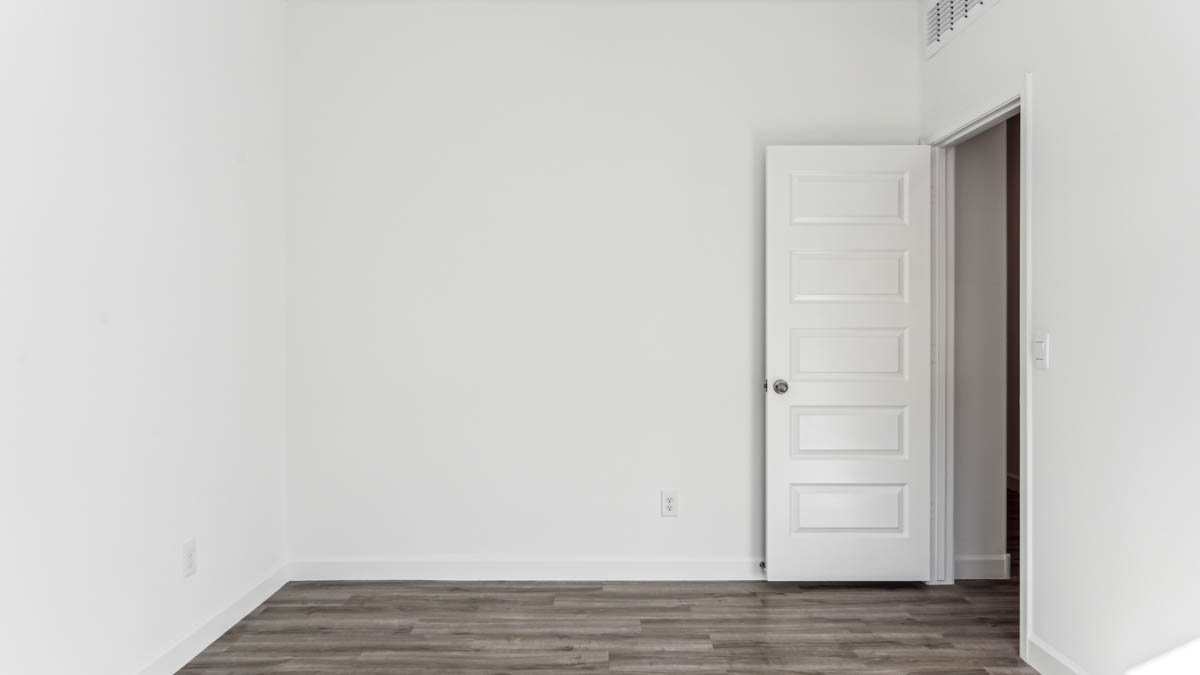 Comfortable guest bedroom featuring neutral-toned walls and a large closet.