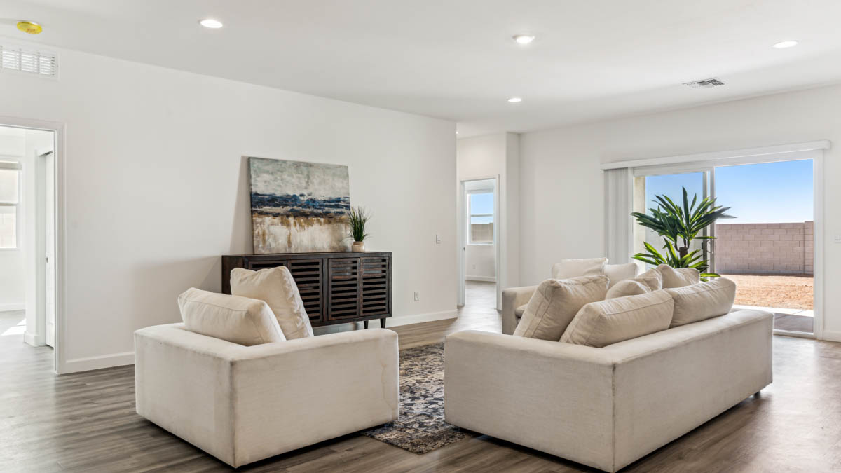 A well-organized living room that includes a kitchen and dining area, creating a warm and welcoming environment for gatherings.