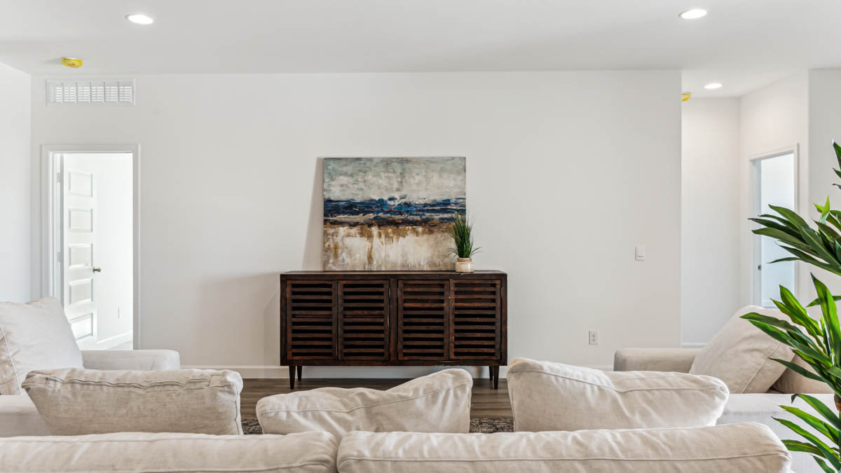 A well-organized living room that includes a kitchen and dining area, creating a warm and welcoming environment for gatherings.