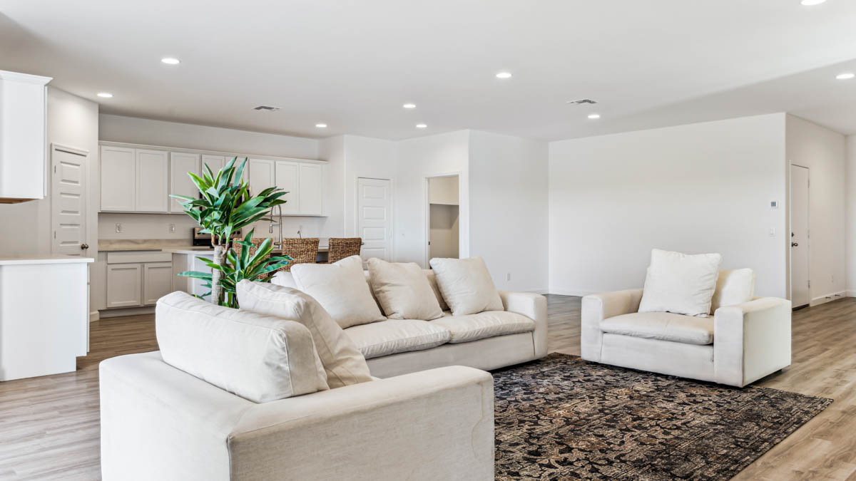 A well-organized living room that includes a kitchen and dining area, creating a warm and welcoming environment for gatherings.