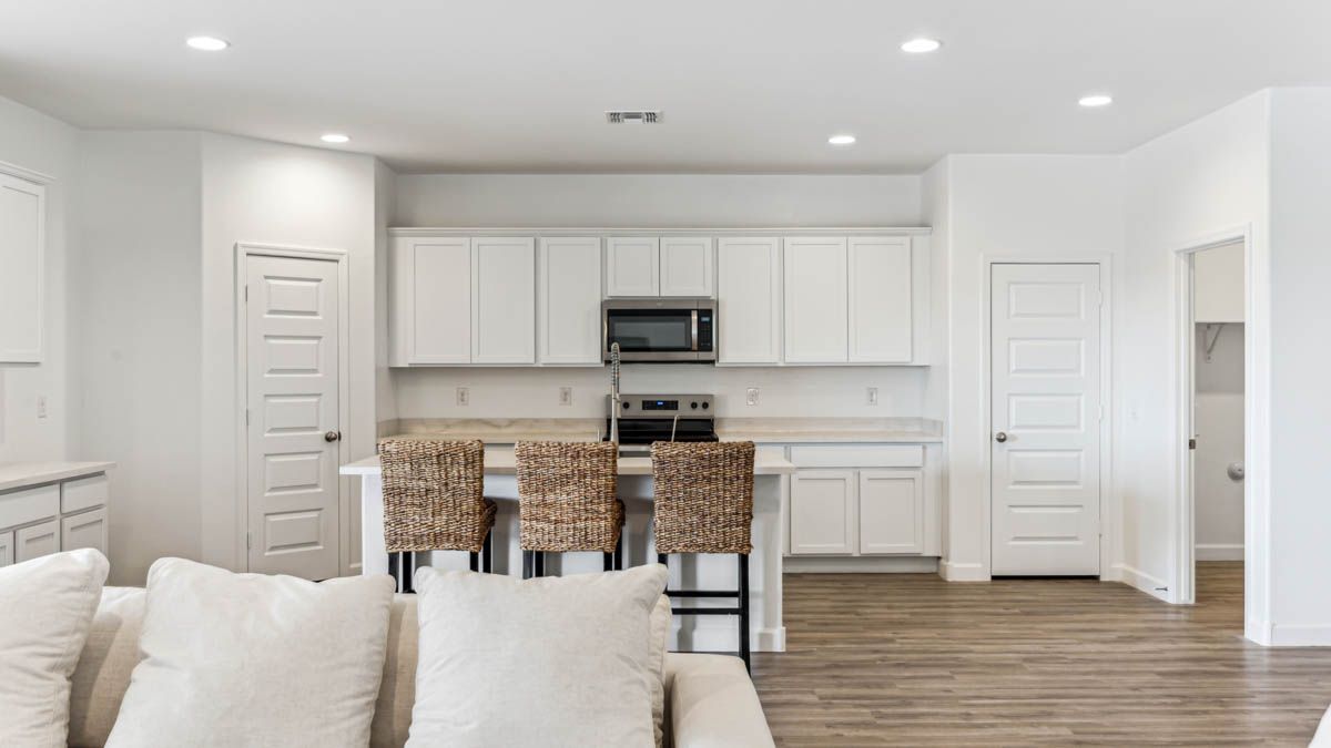 A well-organized living room that includes a kitchen and dining area, creating a warm and welcoming environment for gatherings.