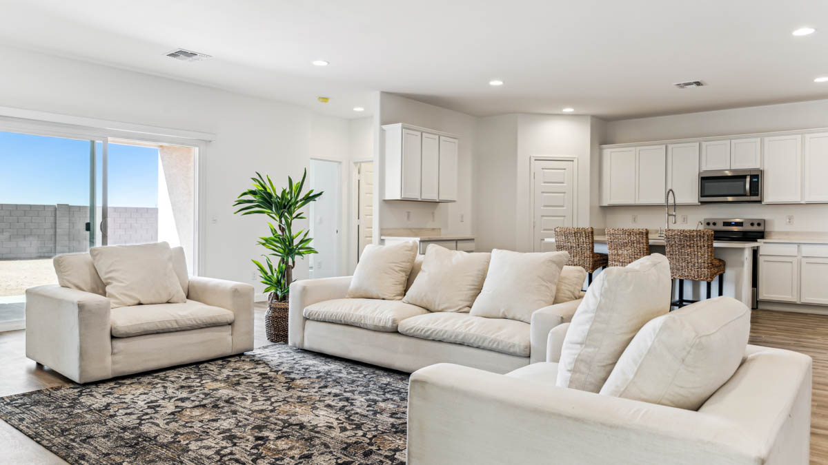 A well-organized living room that includes a kitchen and dining area, creating a warm and welcoming environment for gatherings.