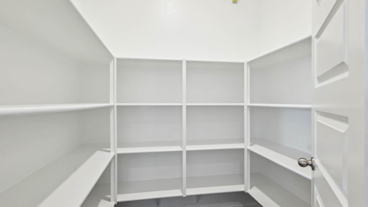 Bright and spacious kitchen with granite countertops, stainless steel appliances, and an island with bar seating.
