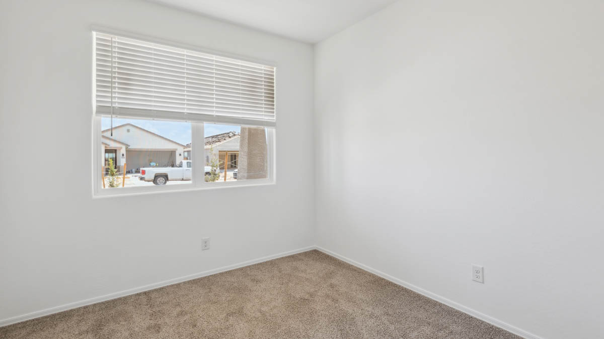Comfortable guest bedroom featuring neutral-toned walls and a large closet.