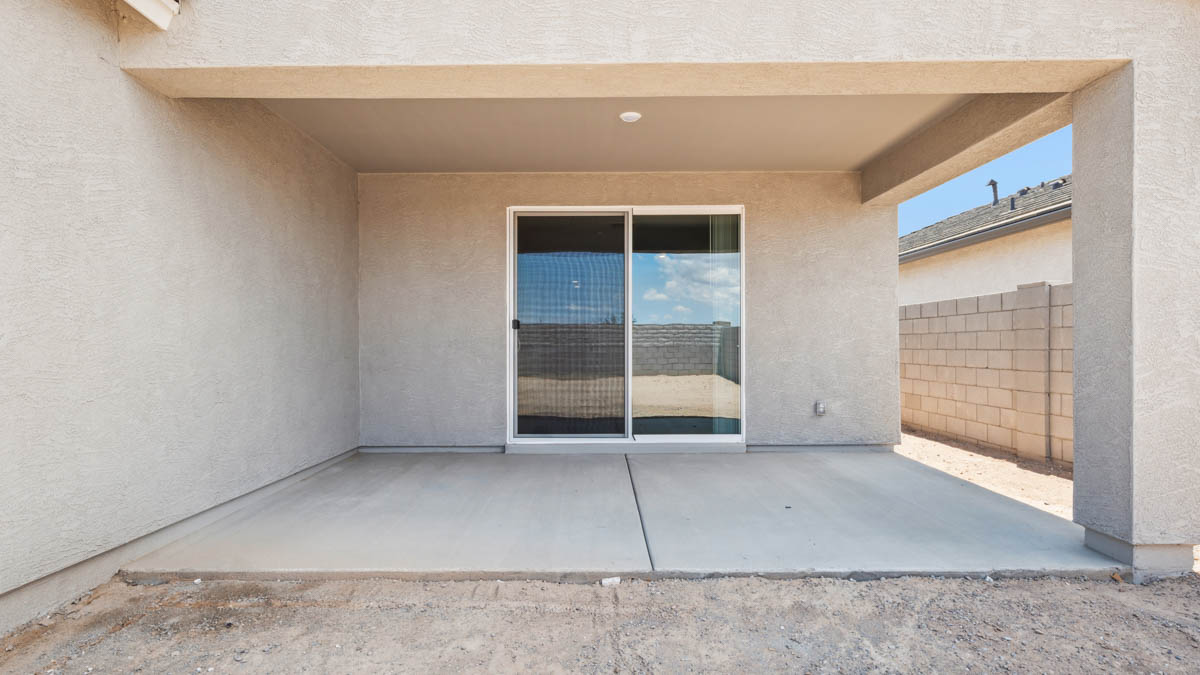 Large fenced-in backyard with a covered patio, perfect for outdoor entertaining.