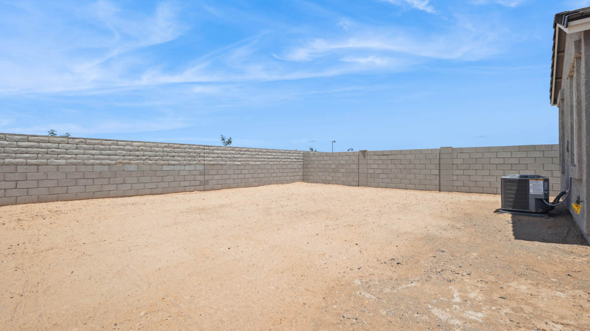 Large fenced-in backyard with a covered patio, perfect for outdoor entertaining.
