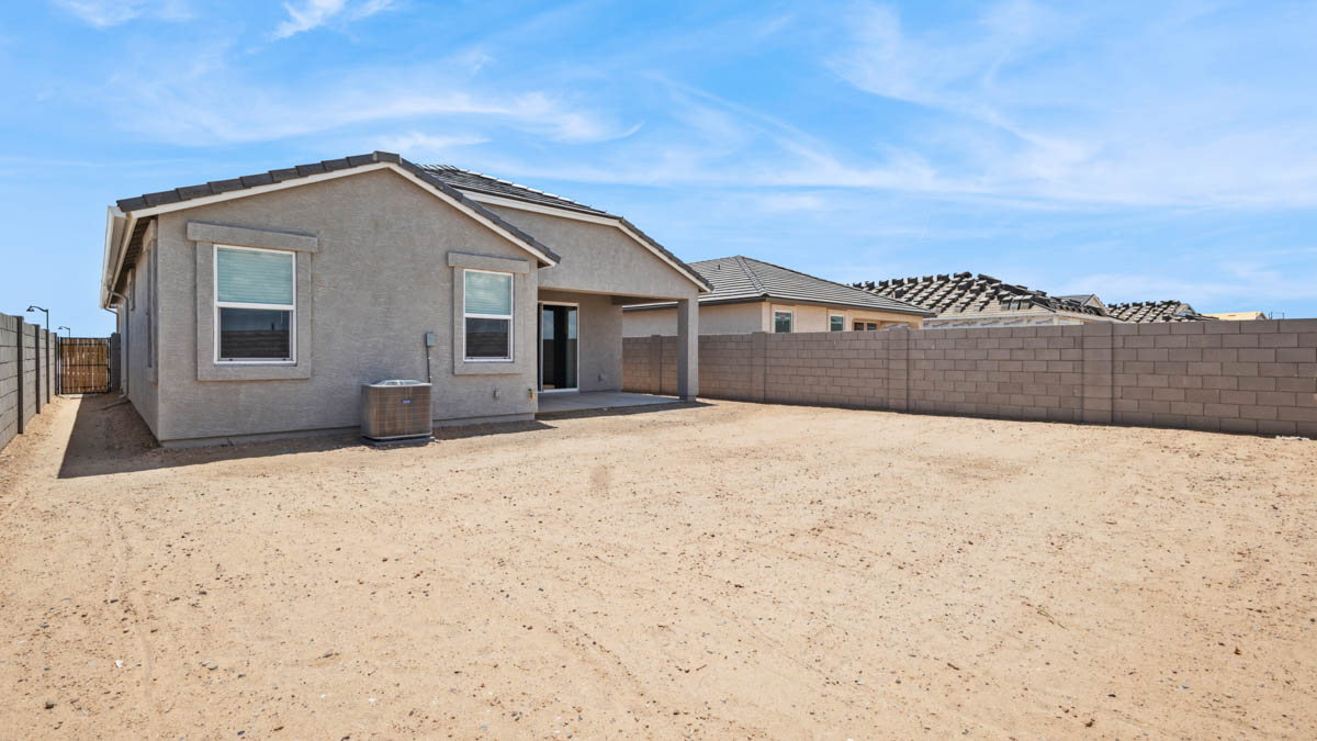 Large fenced-in backyard with a covered patio, perfect for outdoor entertaining.