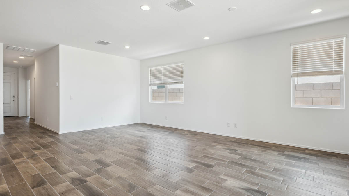 A well-organized living room that includes a kitchen and dining area, creating a warm and welcoming environment for gatherings.