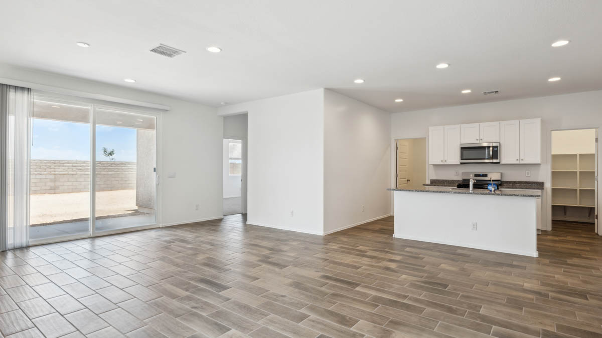 A well-organized living room that includes a kitchen and dining area, creating a warm and welcoming environment for gatherings.