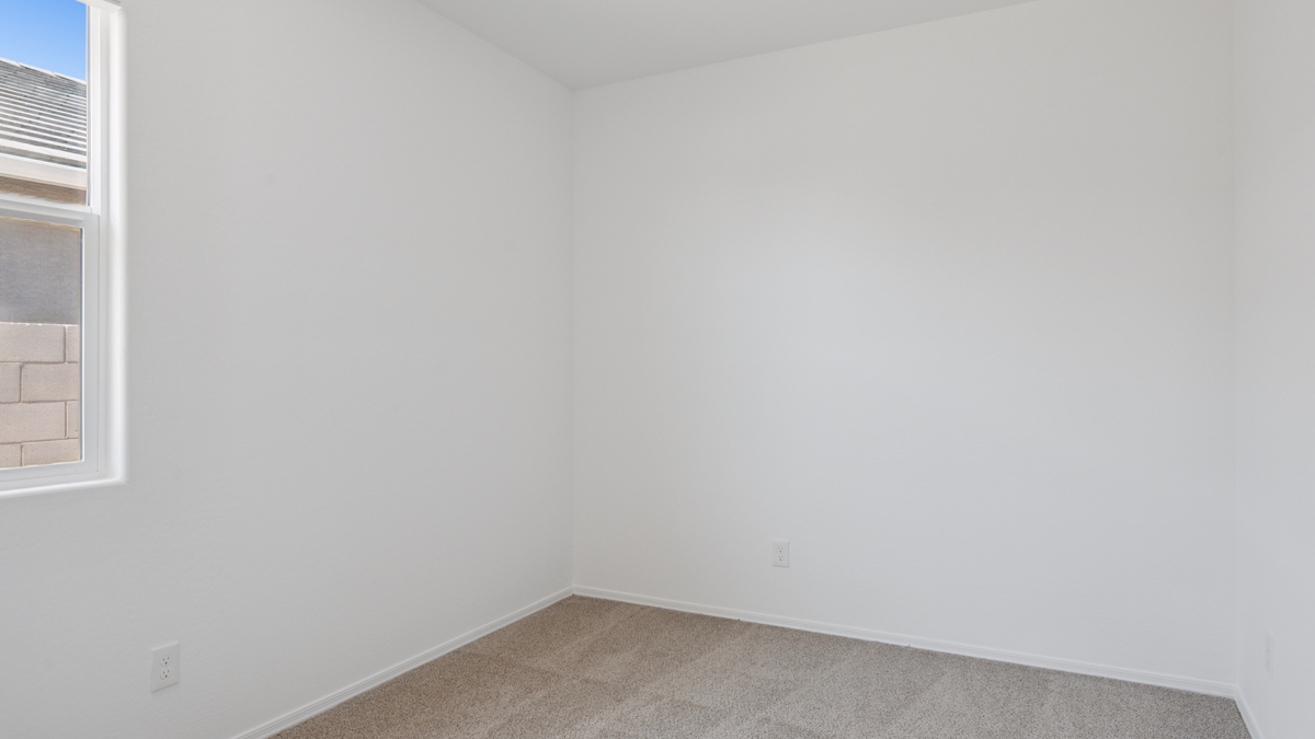 Comfortable guest bedroom featuring neutral-toned walls and a large closet.