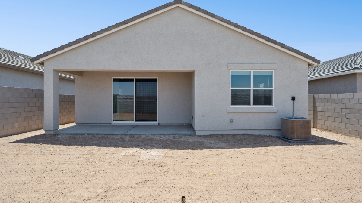 Large fenced-in backyard with a covered patio, perfect for outdoor entertainment.