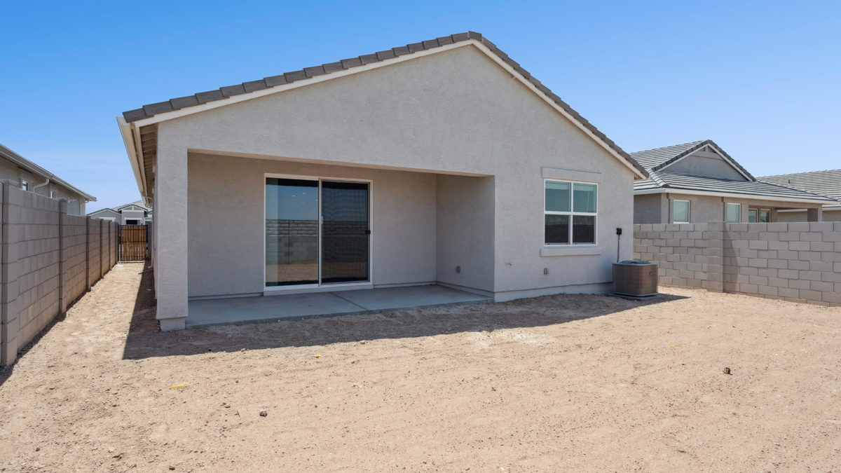 Large fenced-in backyard with a covered patio, perfect for outdoor entertainment.