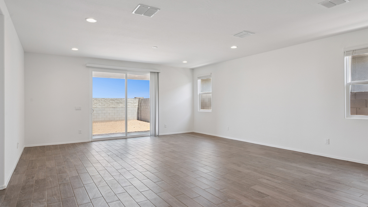 A well-organized living room that includes a kitchen and dining area, creating a warm and welcoming environment for gatherings.