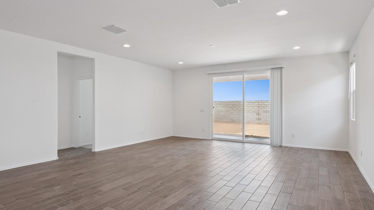 A well-organized living room that includes a kitchen and dining area, creating a warm and welcoming environment for gatherings.