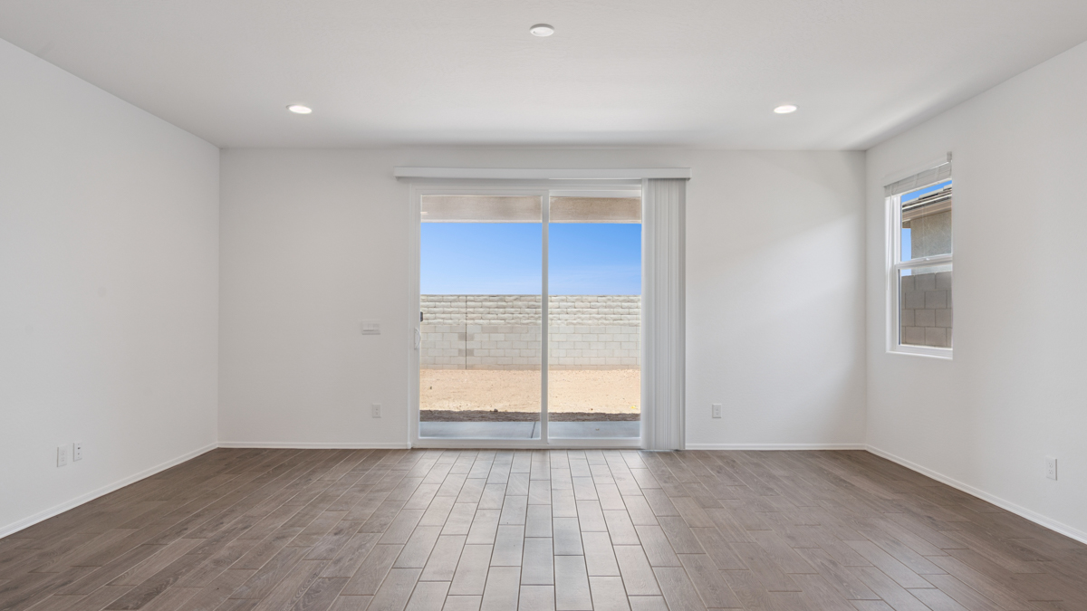 A well-organized living room that includes a kitchen and dining area, creating a warm and welcoming environment for gatherings.