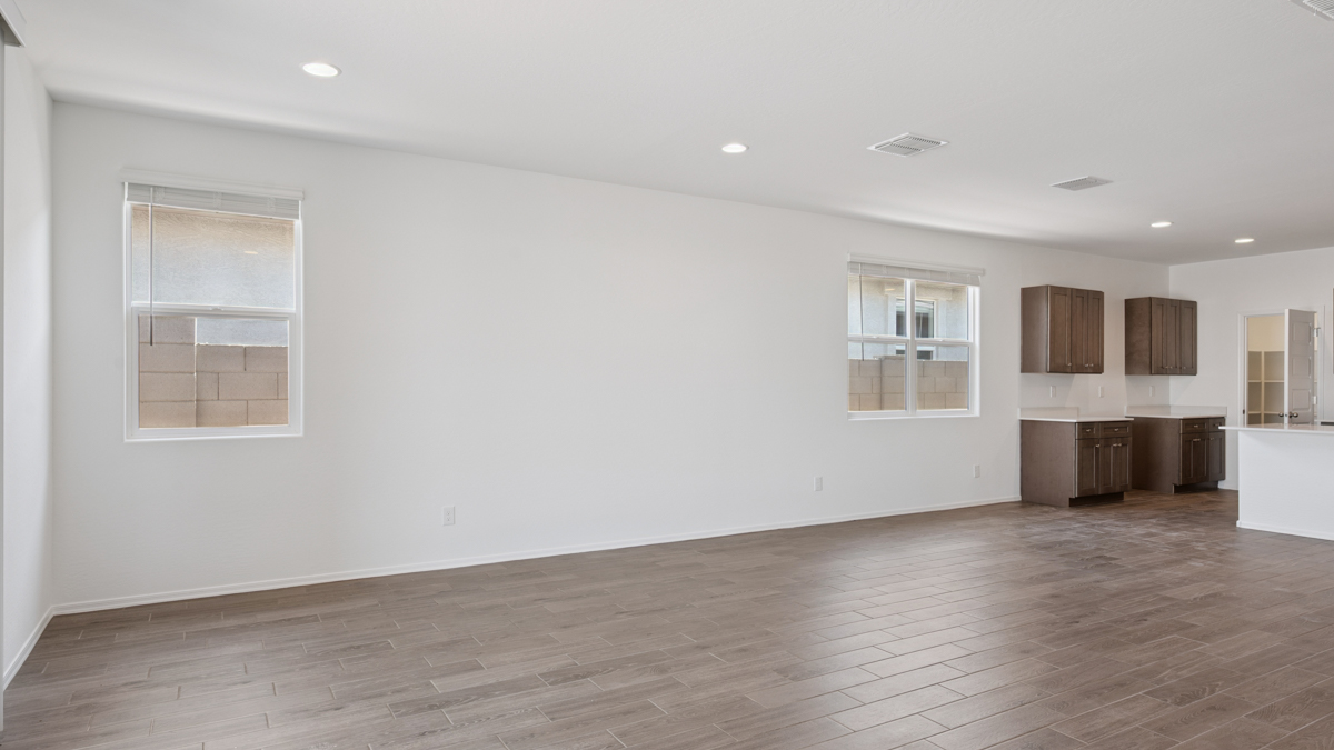 A well-organized living room that includes a kitchen and dining area, creating a warm and welcoming environment for gatherings.