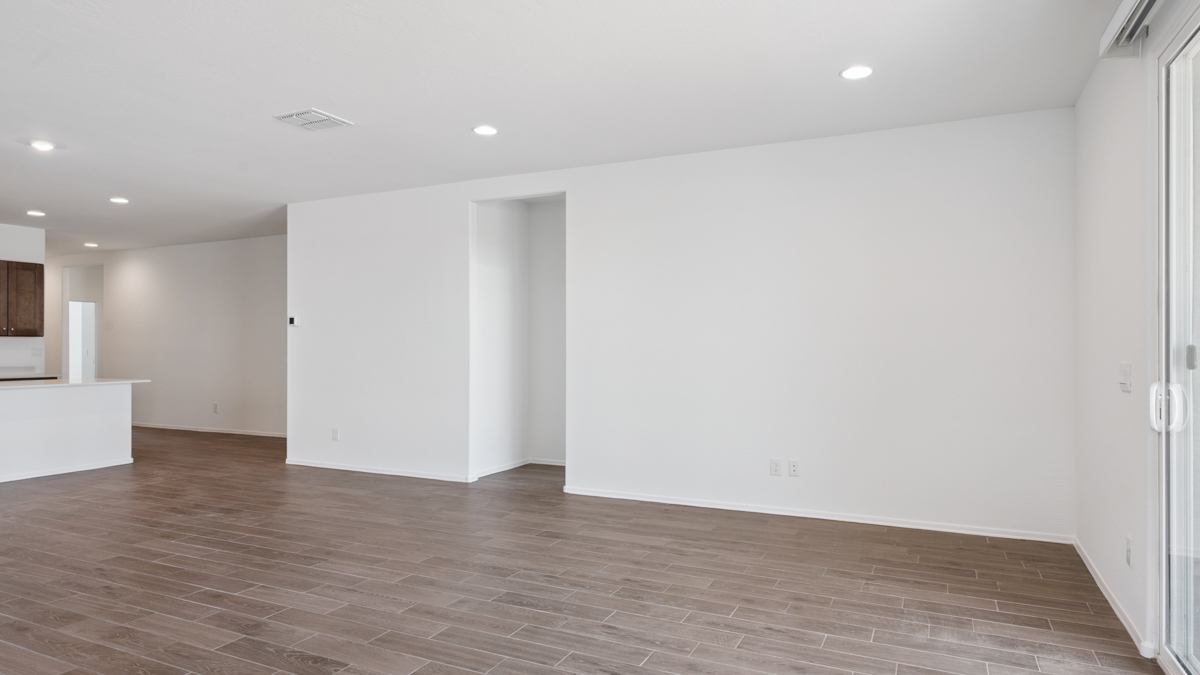 A well-organized living room that includes a kitchen and dining area, creating a warm and welcoming environment for gatherings.