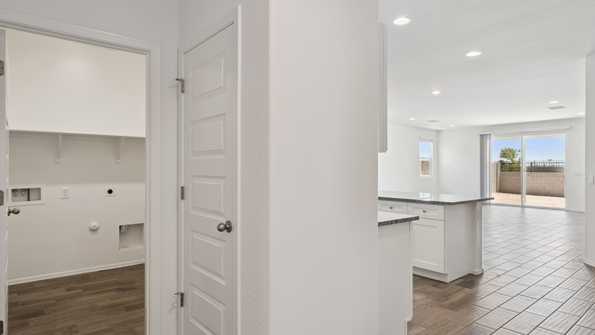 Entry hallway leading to living room and kitchen in the background.